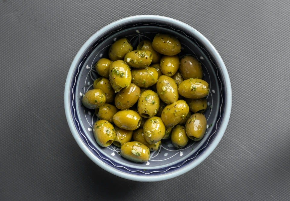 yellow round fruits in blue ceramic bowl